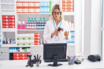 Poster - Young blonde woman pharmacist scanning pills bottle at pharmacy
