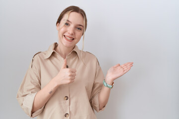 Sticker - Young caucasian woman wearing casual shirt showing palm hand and doing ok gesture with thumbs up, smiling happy and cheerful