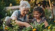 © Ainur - Senior grandmother with granddaughter gardening together in summer