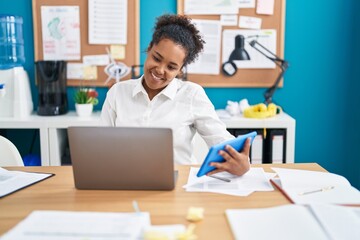 Poster - African american woman business worker using laptop and touchpad at office