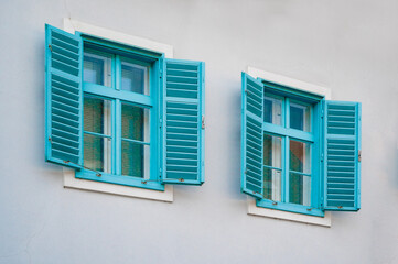 beautiful blue vintage windows with shutters in an old house