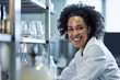 Portrait of smiling female researcher carrying out scientific research in a lab
