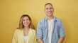 © Krakenimages.com - Man and woman couple smiling confident standing together over isolated yellow background