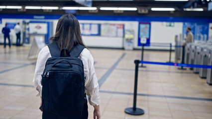 Sticker - Young beautiful hispanic woman walking wearing backpack in subway station of Madrid