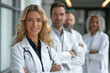 © Sergio - Team of doctors in their medical scrubs standing next to each other, ready to provide medical care and expertise