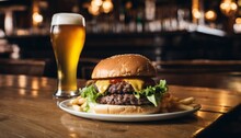 A Hamburger And Fries On A Plate With A Glass Of Beer