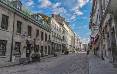 Pedestrian zone with shops, restaurants, city hall and historic architecture in downtown Montréal, Canada around Centre ville with landscaping and flower beds or floral arrangements in shopping area