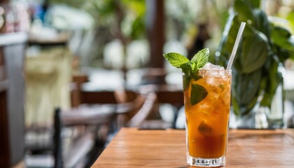 Wall Mural - A glass of iced tea with a mint leaf on top