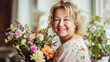 © ximich_natali - A middle-aged woman beaming with happiness, holds a bright bouquet of flowers. Festive spring holidays, mother's day, March 8, teacher's day