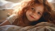© Aleksandr - beautiful child looking at the camera while lying on the bed