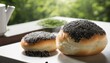 Two rolls with poppy seeds on a white plate