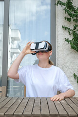 VR.woman uses VR glasses in everyday life at home, augmented reality, VR AR technologies, mixed reality,new future technology, futuristic environment,VR headset,immersive spaces