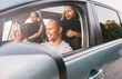© Soloviova Liudmyla - Happy smiling young couple with two daughters inside car during auto trop. They are smiling, and laughing during a road trip. Family values, tatraveling, automotive industry concept.