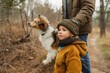 A young girl and her loyal brown dog venture into the wintry woods, their outdoor clothing blending in with the surrounding trees as they explore nature together