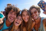 Fototapeta Młodzieżowe - A jubilant group of friends, dressed in colorful summer clothing and donning toothy smiles, stand together under the sunny sky as they capture a moment of fun and friendship with a selfie