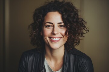 Poster - A woman with curly hair smiling directly at the camera. This picture can be used for various purposes