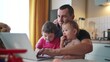 father working from home a remotely with two baby in his arms. pandemic remote work business concept. father tries to work at fun home in kitchen, baby children interfere sitting on their hands