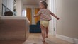 © maxximmm - baby run along the corridor indoors. happy family kid dream concept. baby first steps playing run around at home. son, child, active, runs, takes first steps, plays lifestyle indoors