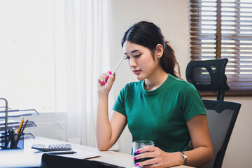 Wall Mural - Businesswoman working at desk using tablet.