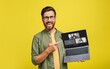 © Prostock-studio - A cheerful man with glasses and a beard excitedly points to a laptop screen displaying