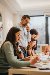 Wall Mural - Professional and concentrated business team collaborating on a project. A diverse group of co-workers engage in a discussion at the office.