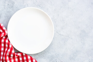 Poster - White plate and napkin at stone table. Table setting, Flat lay image.