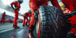 © Oleksandr - Pit crew holding tires in formula 1 pit lane