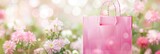 Fototapeta Tulipany - A pink shopping bag with flowers in it. Panoramic springtime banner with flowers, copy-space on abstract pink background.