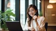 © Eva Corbella - Young happy asian business woman at work