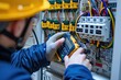 © darshika - Electrician engineer tests voltage and current in electrical cabinet.