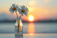 Two White Flowers In A Glass Bottle With A Sunrise In The Background. Concept Of Freshness, Morning.