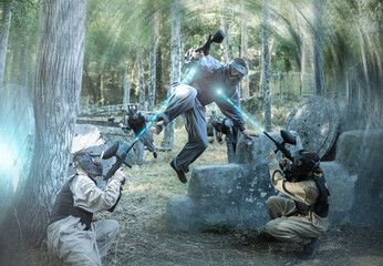 Wall Mural - Teams facing on battlefield in outdoor paintball arena during the match