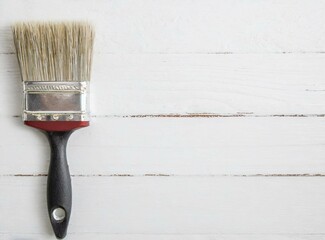 Wall Mural - Paint brush isolated on white wooden background with copy space