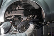 © Михаил Решетников - The master sprays an anti-corrosion compound on the bottom of the car.