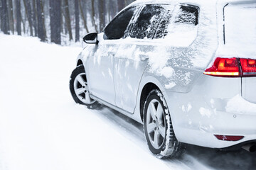 Wall Mural - Car with winter tires on snowy road outdoors, space for text