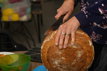 woman cutting a loaf of freshly baked homemade bread 2