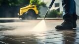 Fototapeta  - Deep cleaning under high pressure. Workers cleaning driveway with pressure washer, professional cleaning service