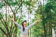 © joyfotoliakid - Asian women raise their hands to nature in the forest .people protect from deforestation and pollution or climate change Concept to love nature and tree . environment ecology and Earth Day concept