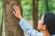 © joyfotoliakid - Human hand Hug and touching tree in the forest .people protect from deforestation and pollution or climate change Concept to love nature and tree . environment ecology and Earth Day concept