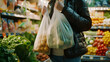Plastic-Free Shopping: A person using reusable bags and containers to shop for groceries, avoiding single-use plastics. Professional stock photography.