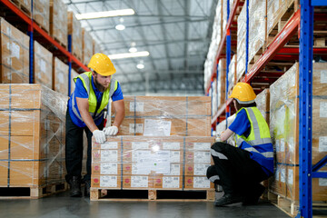 workers using Laser Barcode Scanner to checking stock items for shipping. male and female inspecting the store factory. industry factory warehouse. Logistics employees working at warehouse management.