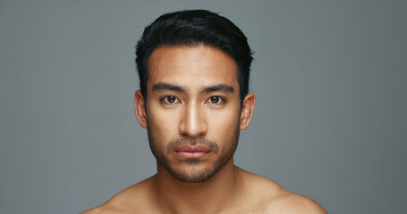 Poster - Face, cosmetics and Asian man with beauty, skincare and dermatology on a grey studio background. Portrait, Japanese person and model with wellness, luxury treatment and spa grooming with aesthetic