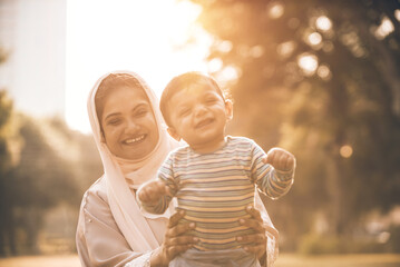 Wall Mural - Mother and baby son lifestyle moments in Dubai. Young woman with her kid outdoor. Family concepts in the UAE