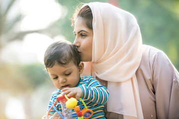 Wall Mural - Mother and baby son lifestyle moments in Dubai. Young woman with her kid outdoor. Family concepts in the UAE