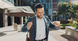 © HockleyMedia/peopleimages.com - Happy, smile and businessman dancing in city for good news, achievement or celebration. Excited, success and professional young male person moving and singing with briefcase to music in urban town.