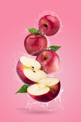 Canvas Print - Fresh Red apples and Red apple slices with water splashing on a Pink background. Fruit minimal concept and copy space.