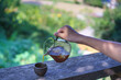 person pouring a glass of drip coffee