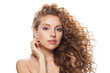 © artmim - Charming healthy model with natural make-up, shiny clear skin and long curly hairstyle showing her ear with diamond jewelry earring isolated on white background