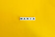 Mania Word and Banner. Text on Block Letter Tiles on Yellow Background. Minimalist Aesthetics.