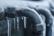 © mihrzn - Close-up view of frozen water pipes with icicles forming, capturing the impact of the cold on the environment.